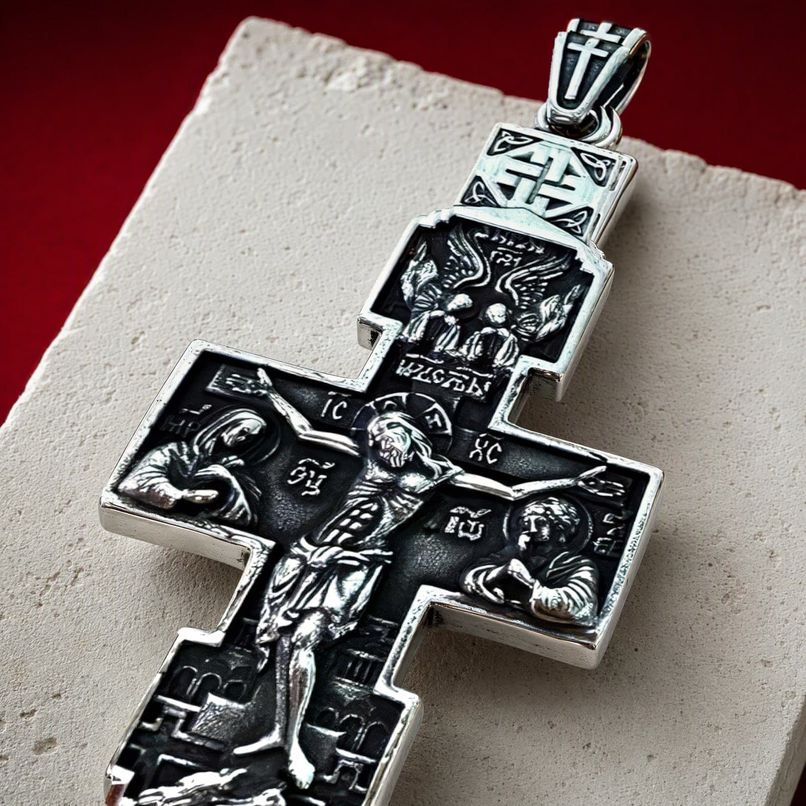Close-up of the Orthodox Crucifix - Silver Color - Stainless Steel Cross 20.2g: the relief and the bail in raking light.