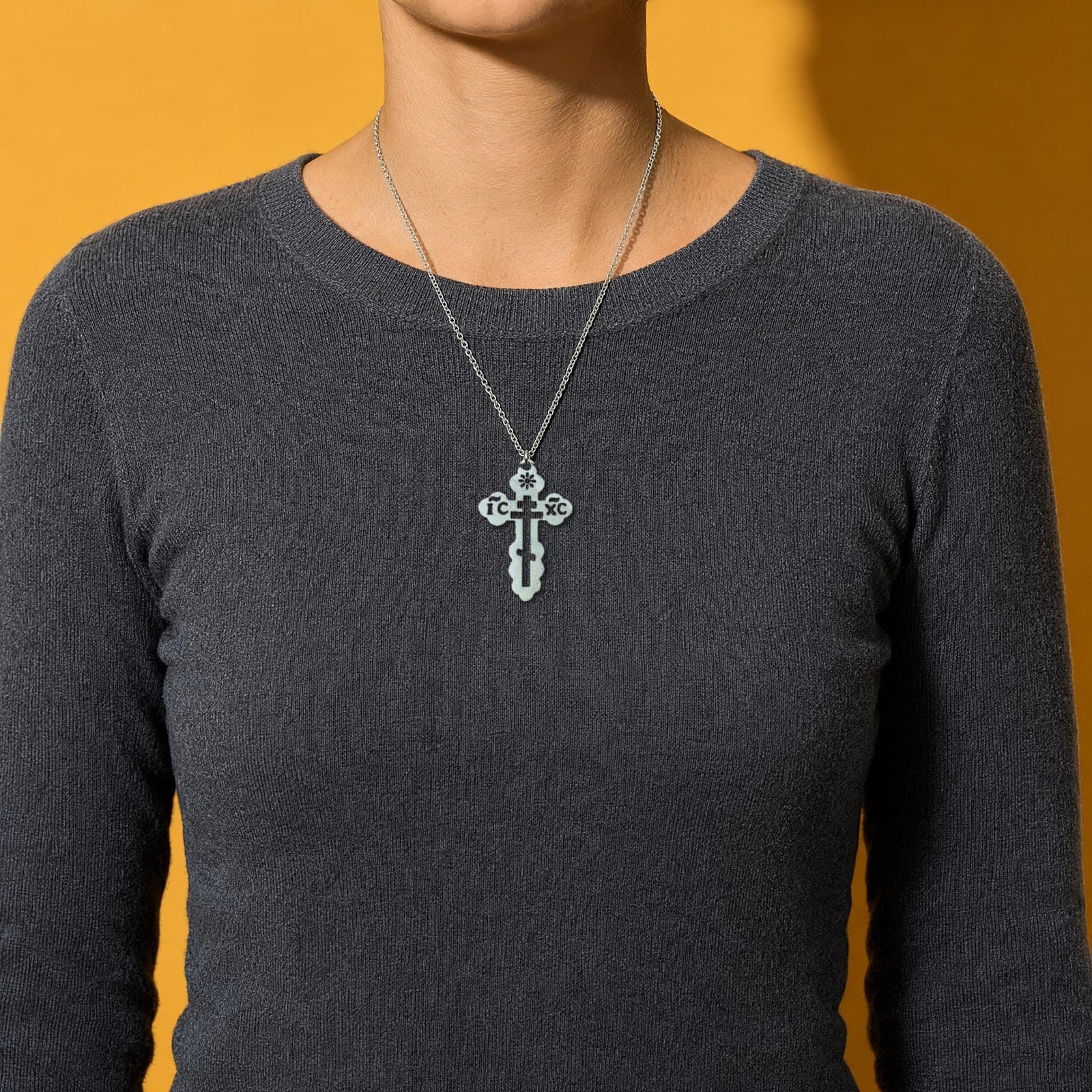 Orthodox IC XC - Silver Color - Stainless Steel Cross worn on a woman's chest at its true size (5.5 cm).