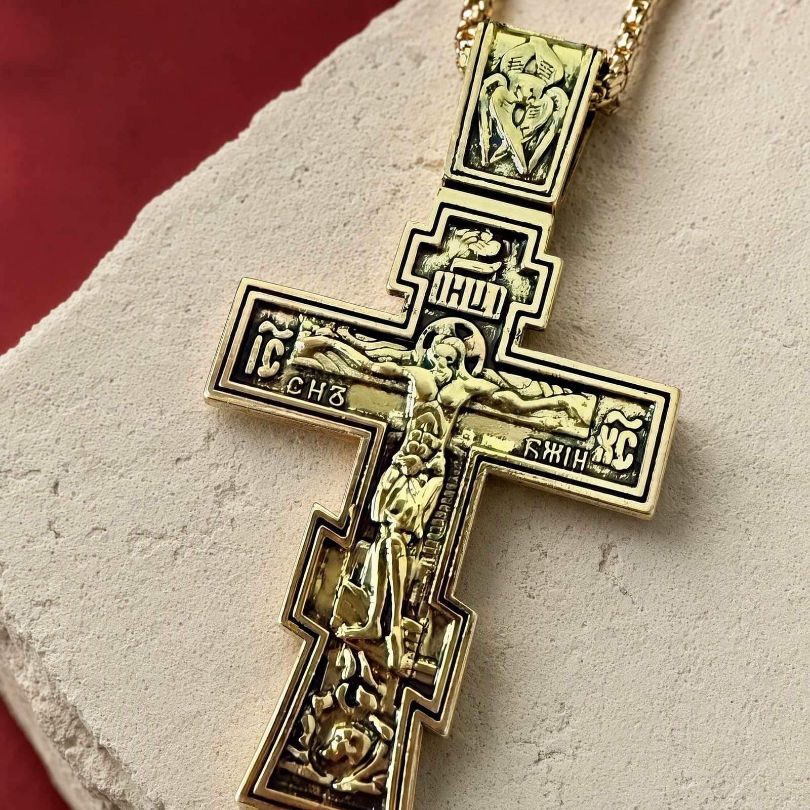 Close-up of the Orthodox Crucifix - 60cm Chain - Gold Color - Stainless Steel Cross: the relief and the bail in raking light.