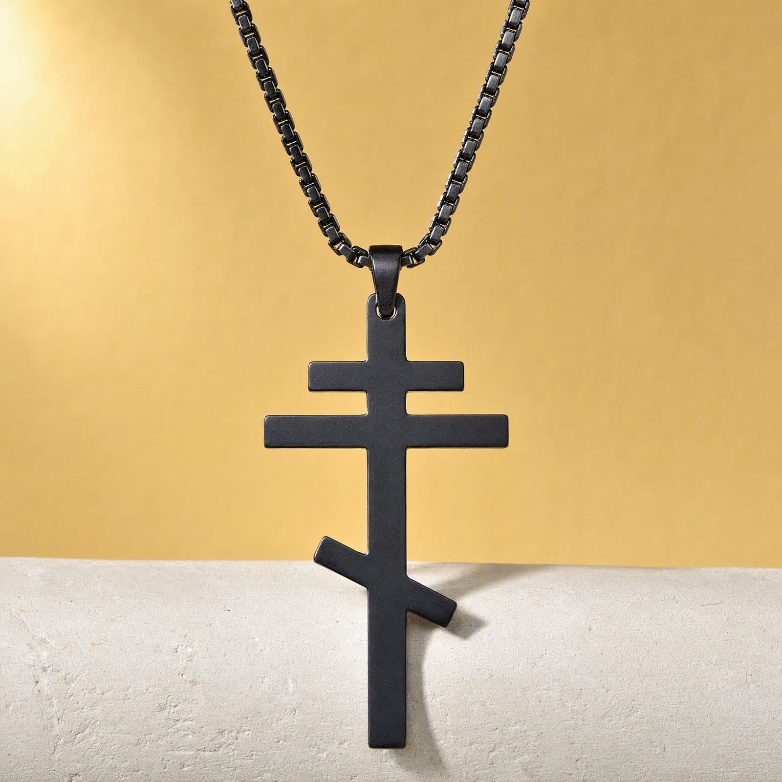 Orthodox Crucifix, black stainless steel cross: close-up of the front relief, on its chain.