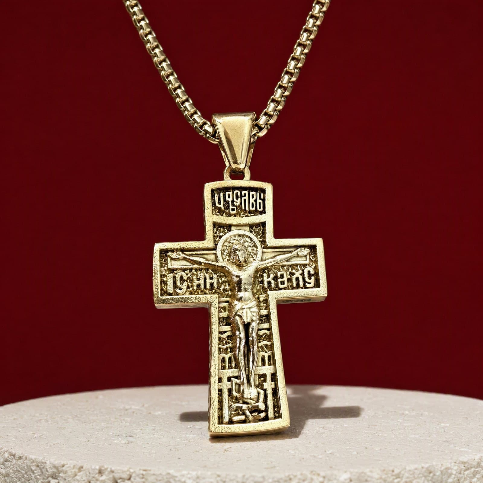 Orthodox Crucifix (King of Glory), gold-tone stainless steel cross: close-up of the front relief, on its chain.