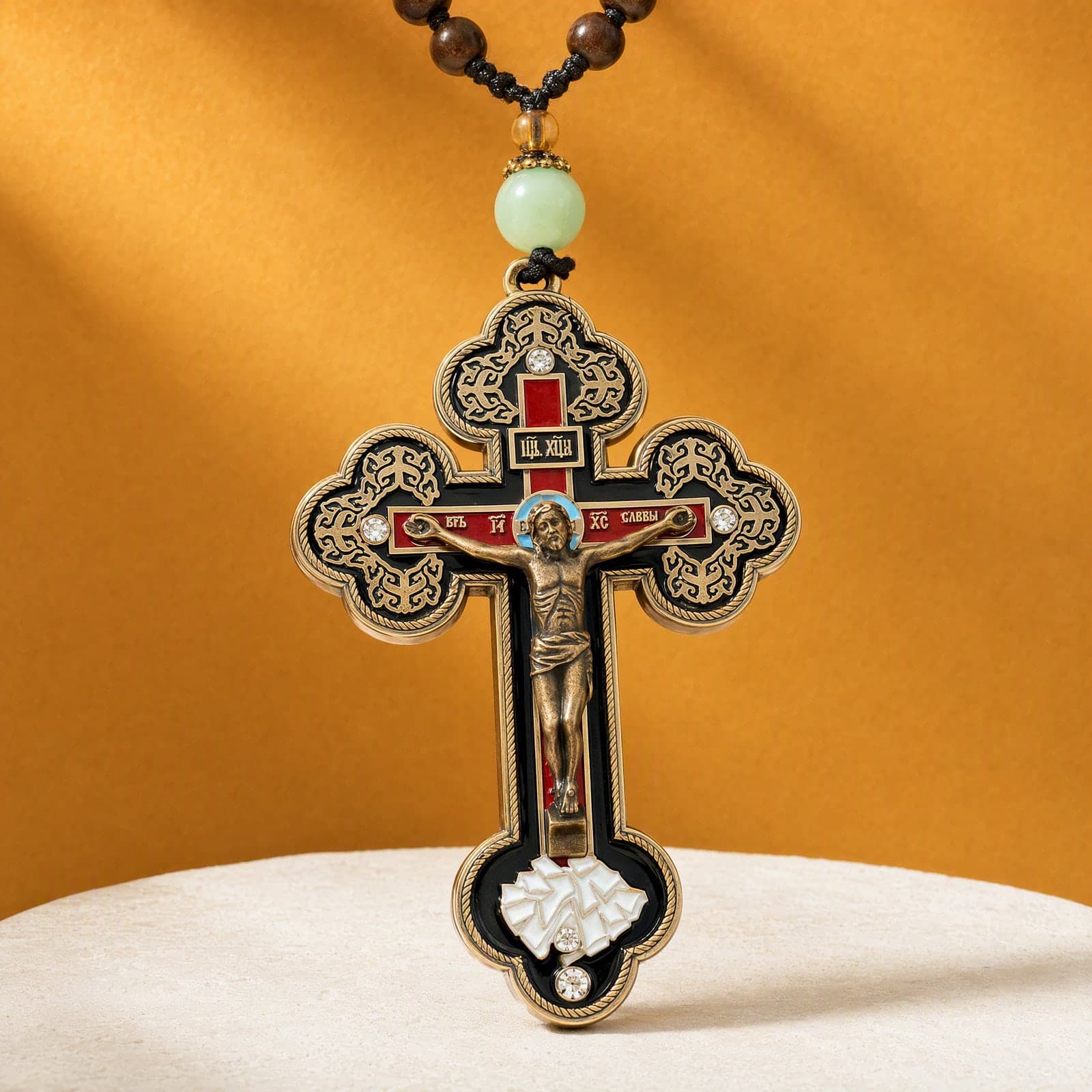 Orthodox Crucifix, bronze-tone cross: close-up of the front relief, on its cord.