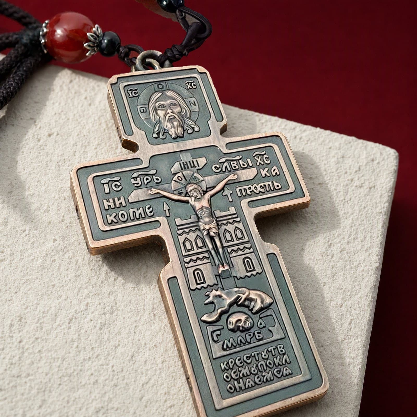 Close-up of the Orthodox Crucifix (Holy Face, Copper) - Bronze Color - Stainless Steel Cross: the relief and the bail in raking light.