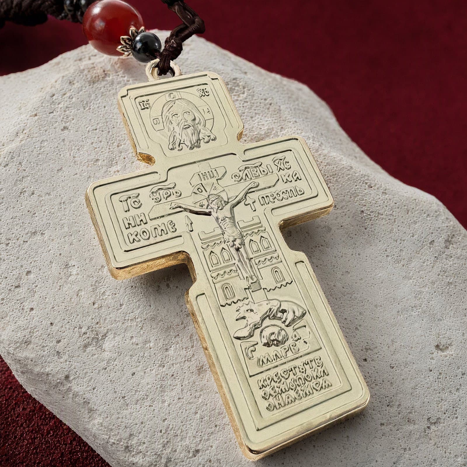 Close-up of the Orthodox Crucifix (Holy Face) - Silver Color - Stainless Steel Cross: the relief and the bail in raking light.