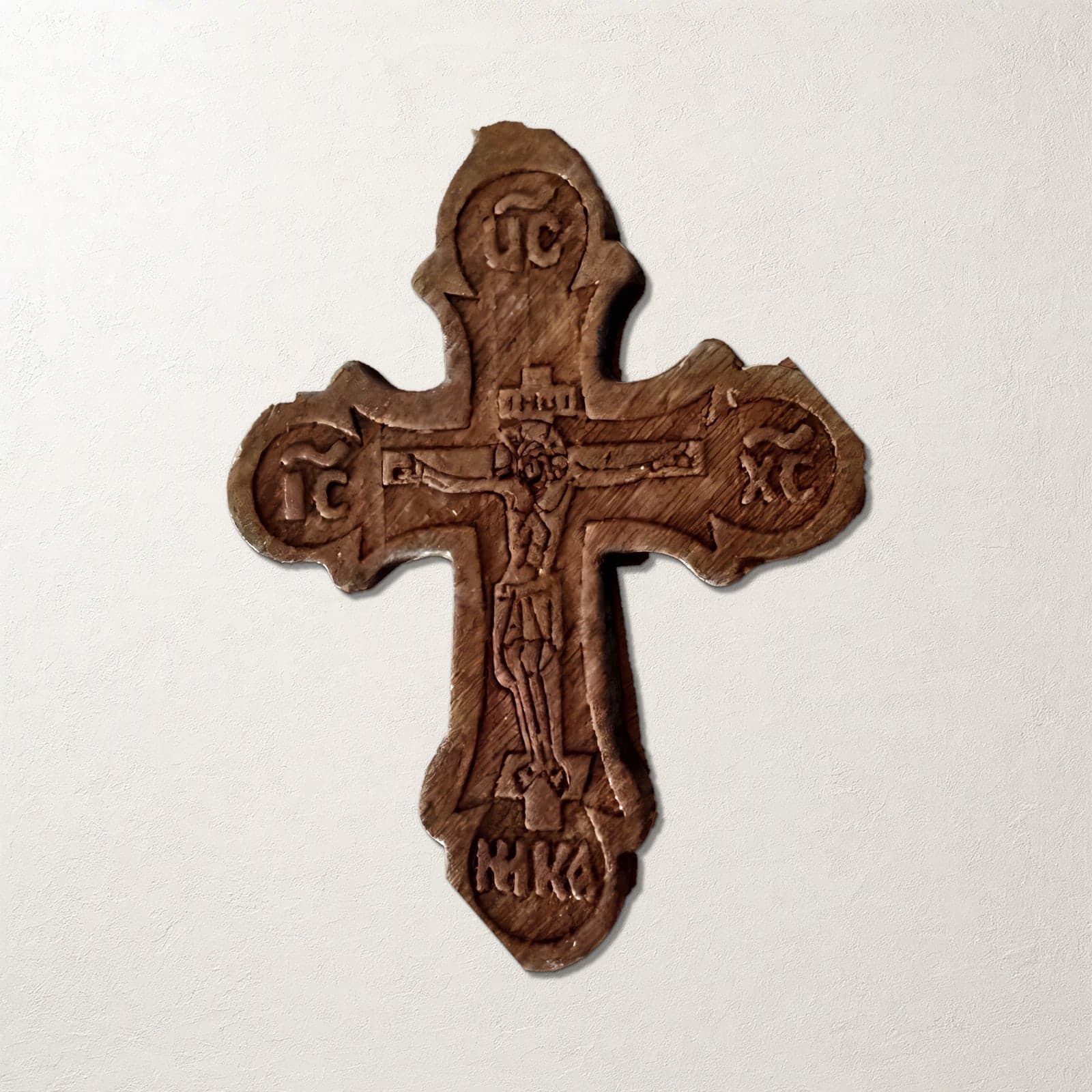 Orthodox Crucifix - Wooden Cross: a carved light-brown wooden Orthodox cross with trefoil ends, on bone paper.