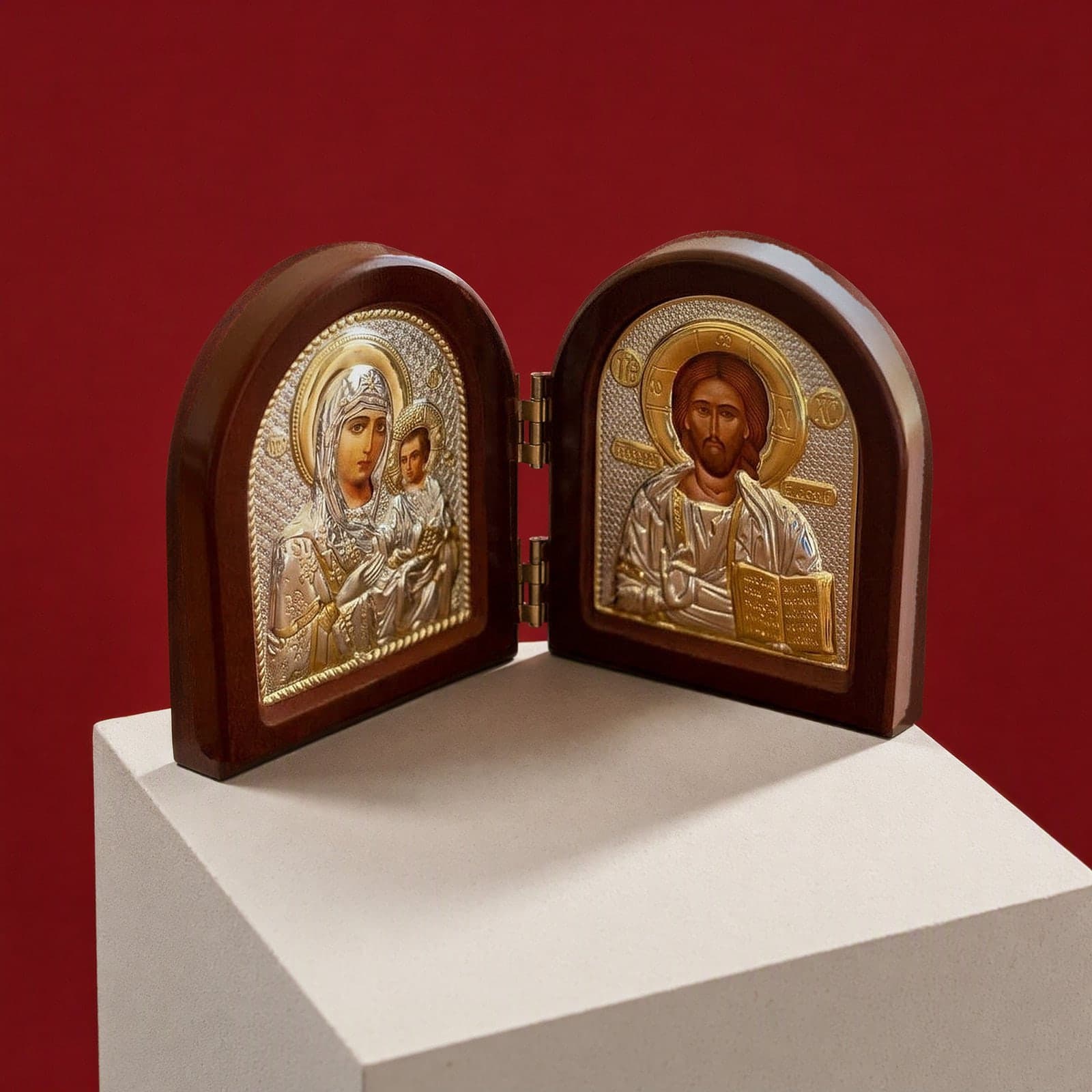 Orthodox Jesus Christ and Virgin Mary - Folding Wooden Icon seen from a 45-degree angle on a white plinth.