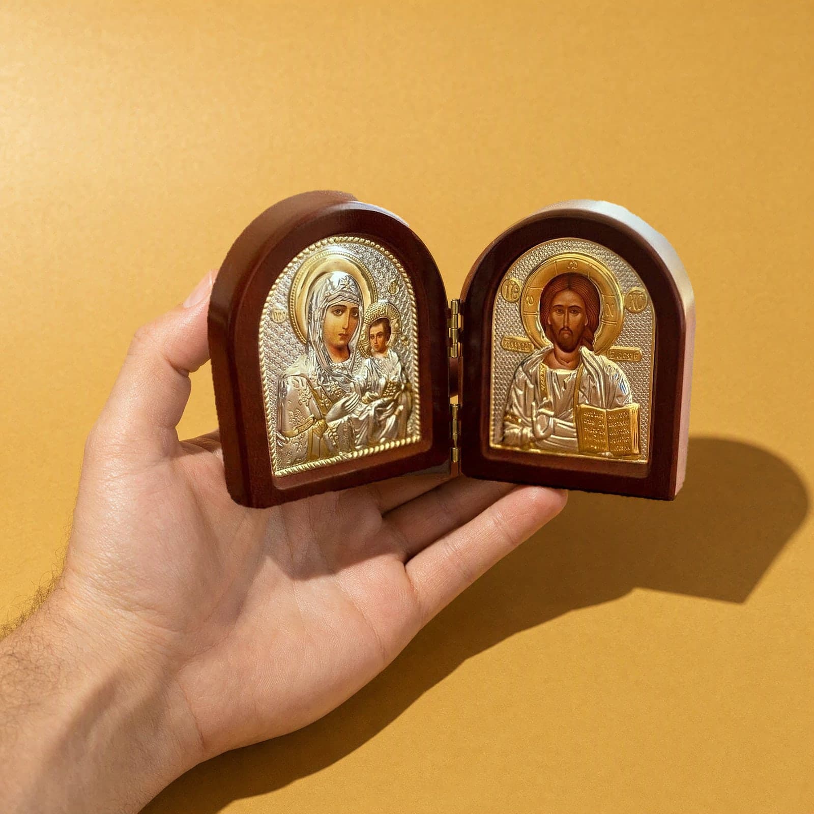Orthodox Jesus Christ and Virgin Mary - Folding Wooden Icon held in one hand to show its size (about 11 x 9 cm).