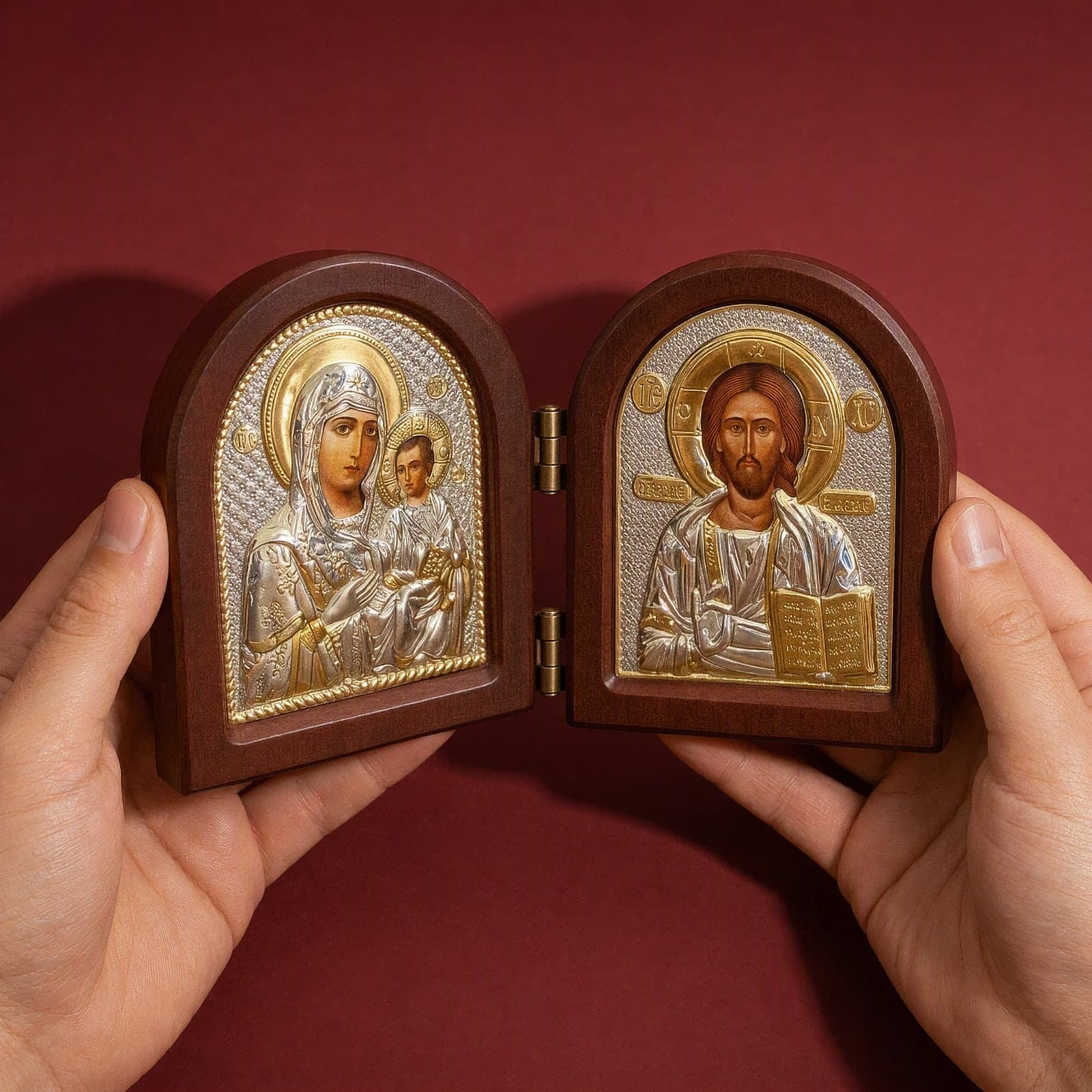 Orthodox Jesus Christ and Virgin Mary, folding wooden icon held open in both hands like a book at its true size (11 x 9 cm).