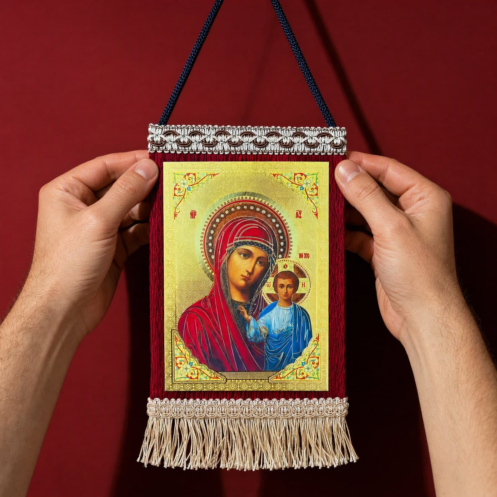 Orthodox Virgin Mary & Jesus, hanging icon (20 × 13 cm) held in both hands at its true size (20 x 13 cm).