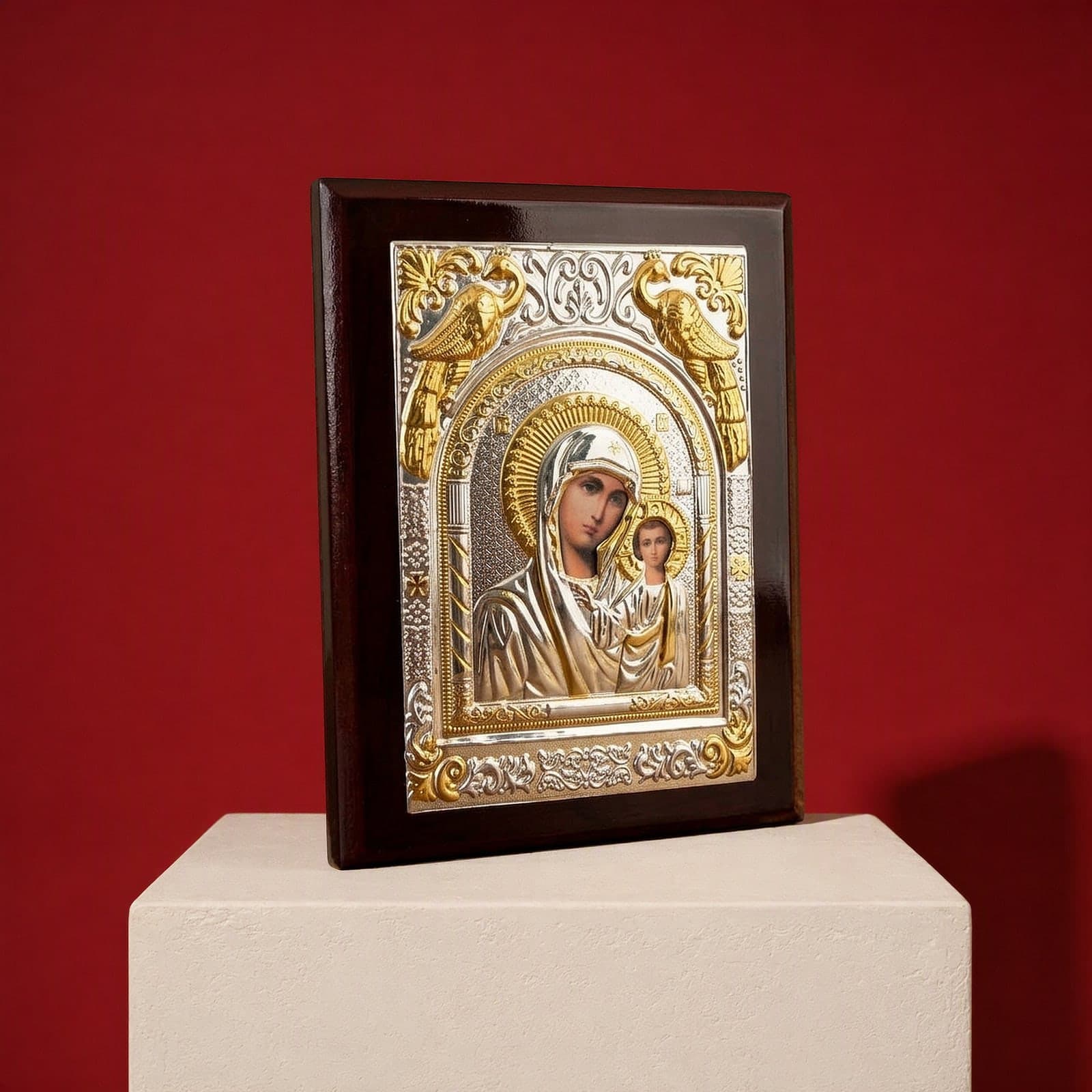 Orthodox Virgin Mary (Our Lady of Kazan, Rectangular) - Silver&Gold Color - Wooden Icon seen from a 45-degree angle on a white plinth.