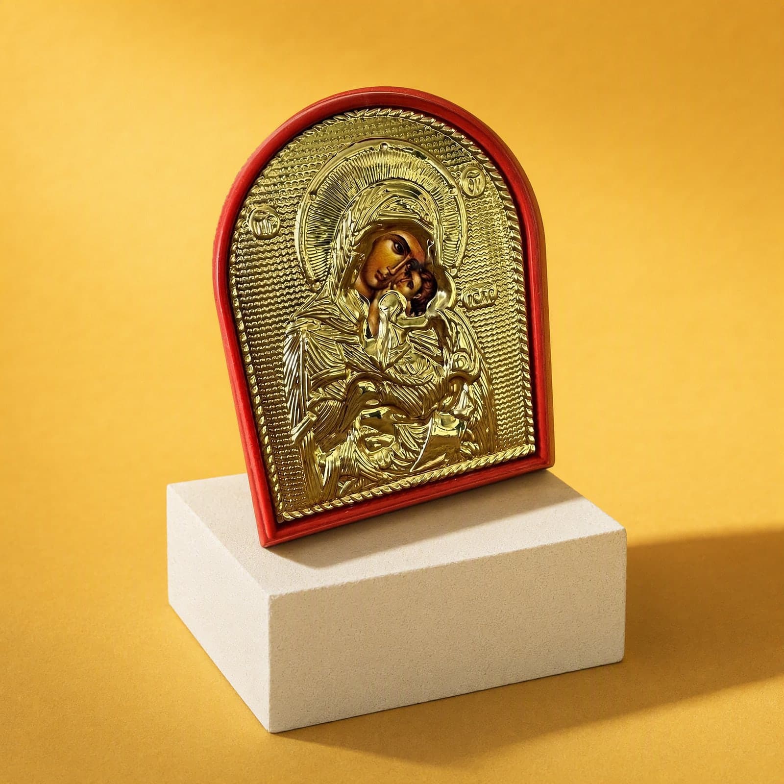Orthodox Mother of God - Gold Color - Wooden Icon seen from a 45-degree angle on a white plinth.