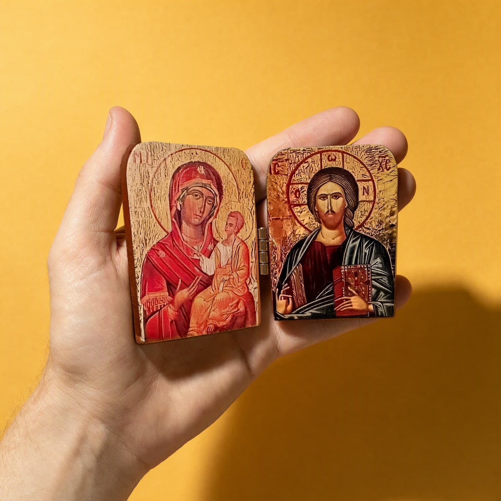 Orthodox Diptych Virgin Mary & Jesus Christ - Folding Wooden Icon held in one hand to show its size (about 12 x 9 cm).