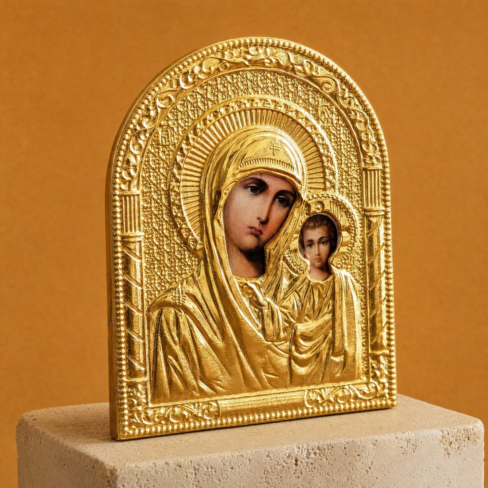 Orthodox Virgin Mary Holding Jesus, gold-tone icon: close-up of the holy image, the foil and the frame.