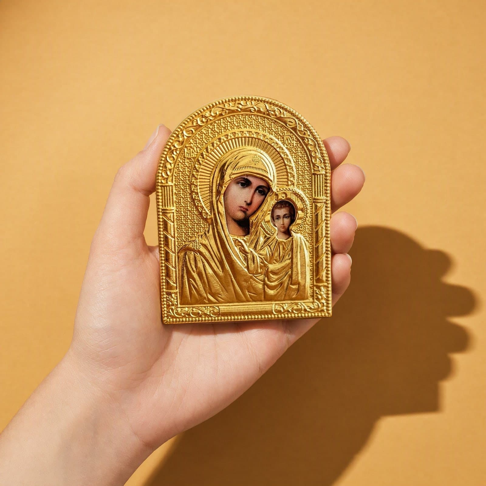 Orthodox Virgin Mary Holding Jesus - Gold Color - Icon held in one hand to show its size (about 14 x 10 cm).