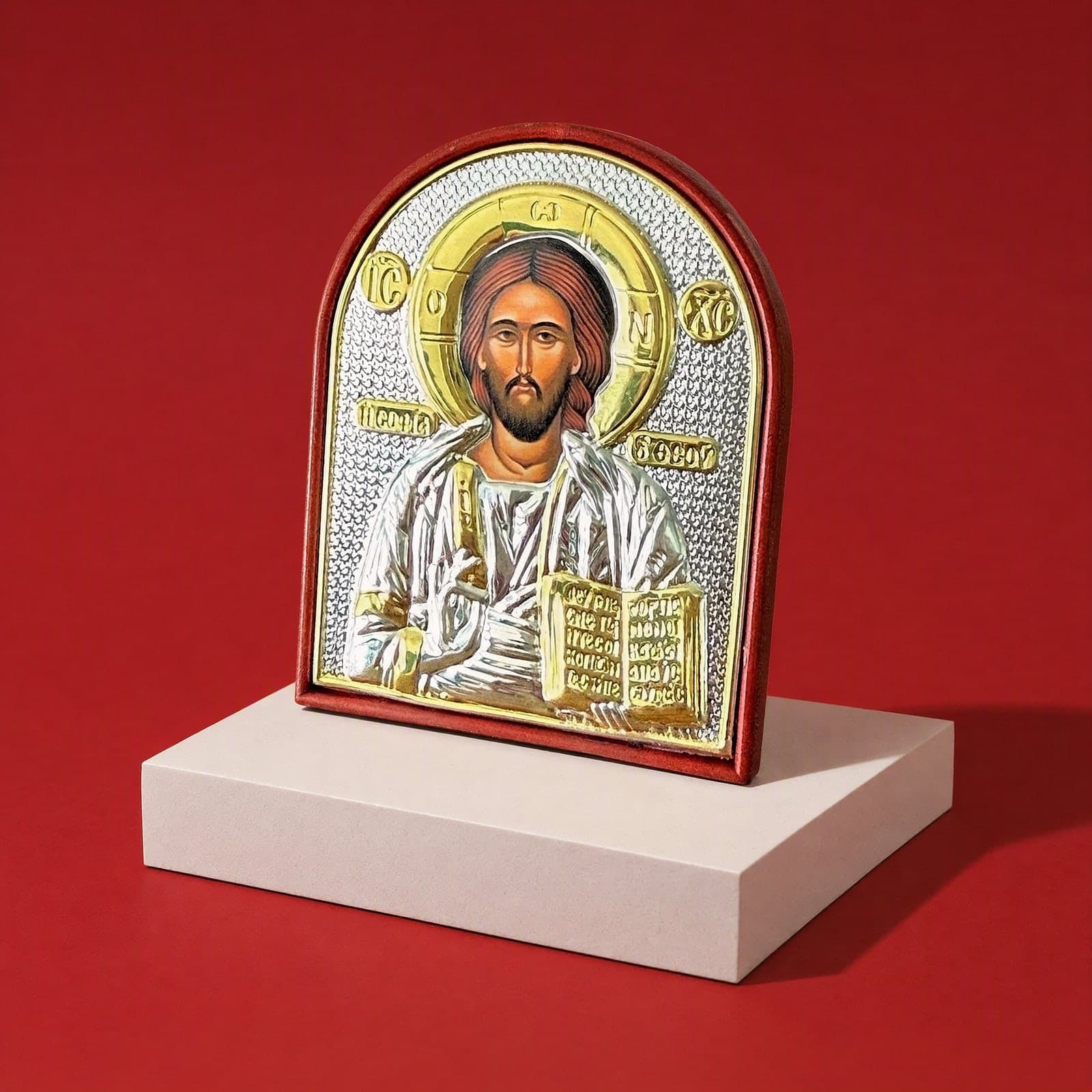 Orthodox Jesus Christ Pantocrator - Silver&Gold Color - Icon seen from a 45-degree angle on a white plinth.