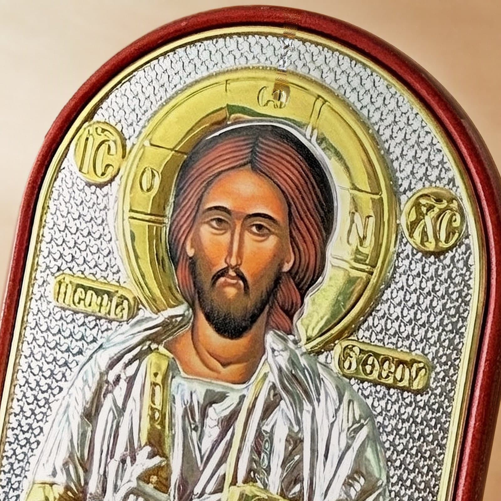 Close-up of the Orthodox Jesus Christ Pantocrator - Silver&Gold Color - Icon: the face, halo and finish.