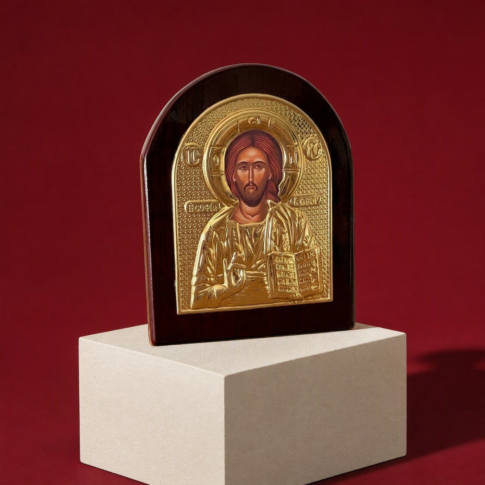 Orthodox Jesus Christ Pantocrator - Gold Color - Wooden Icon seen from a 45-degree angle on a white plinth.