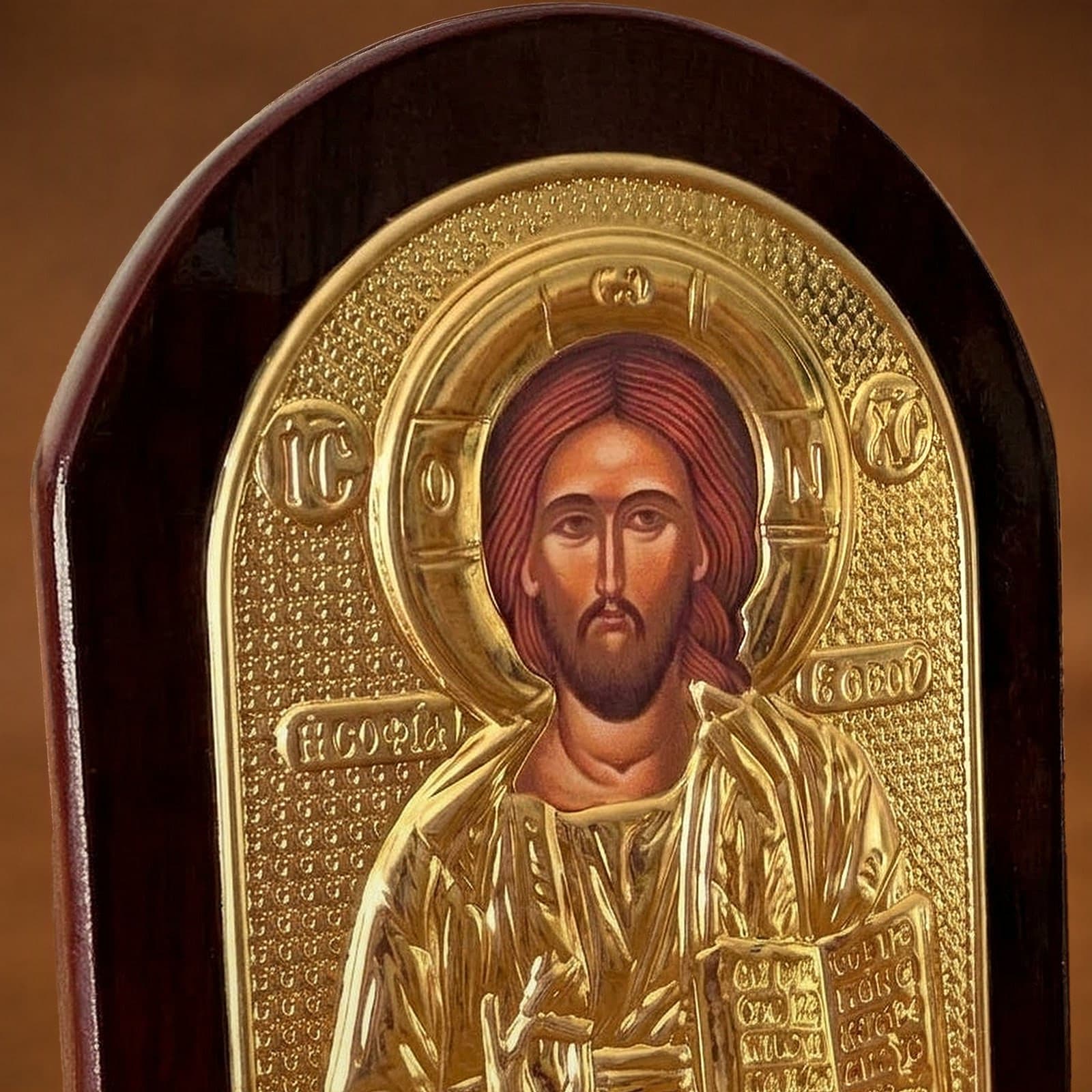 Close-up of the Orthodox Jesus Christ Pantocrator - Gold Color - Wooden Icon: the face, halo and finish.