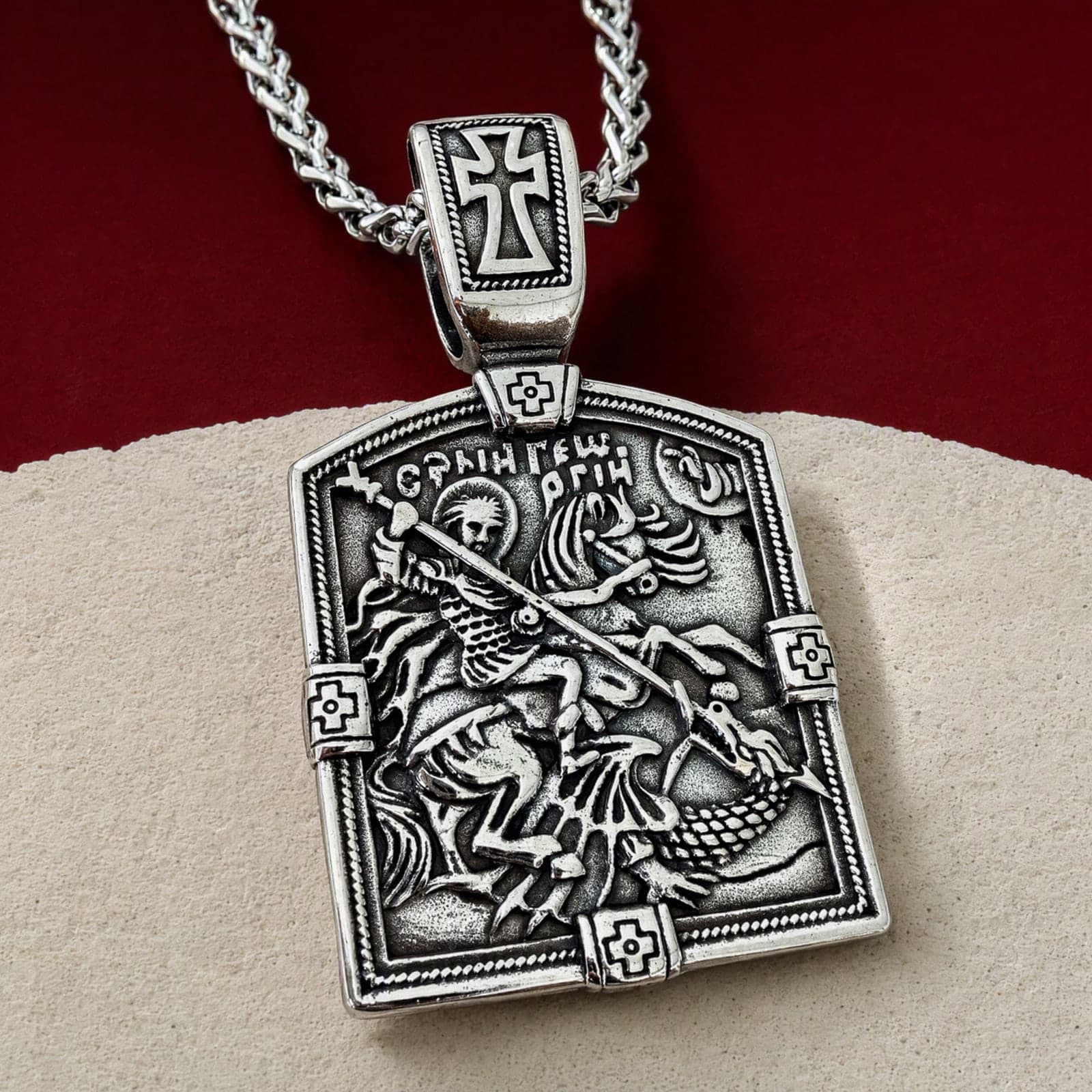 Orthodox St. George, silver-tone stainless steel medallion: close-up of the front relief, on its chain.
