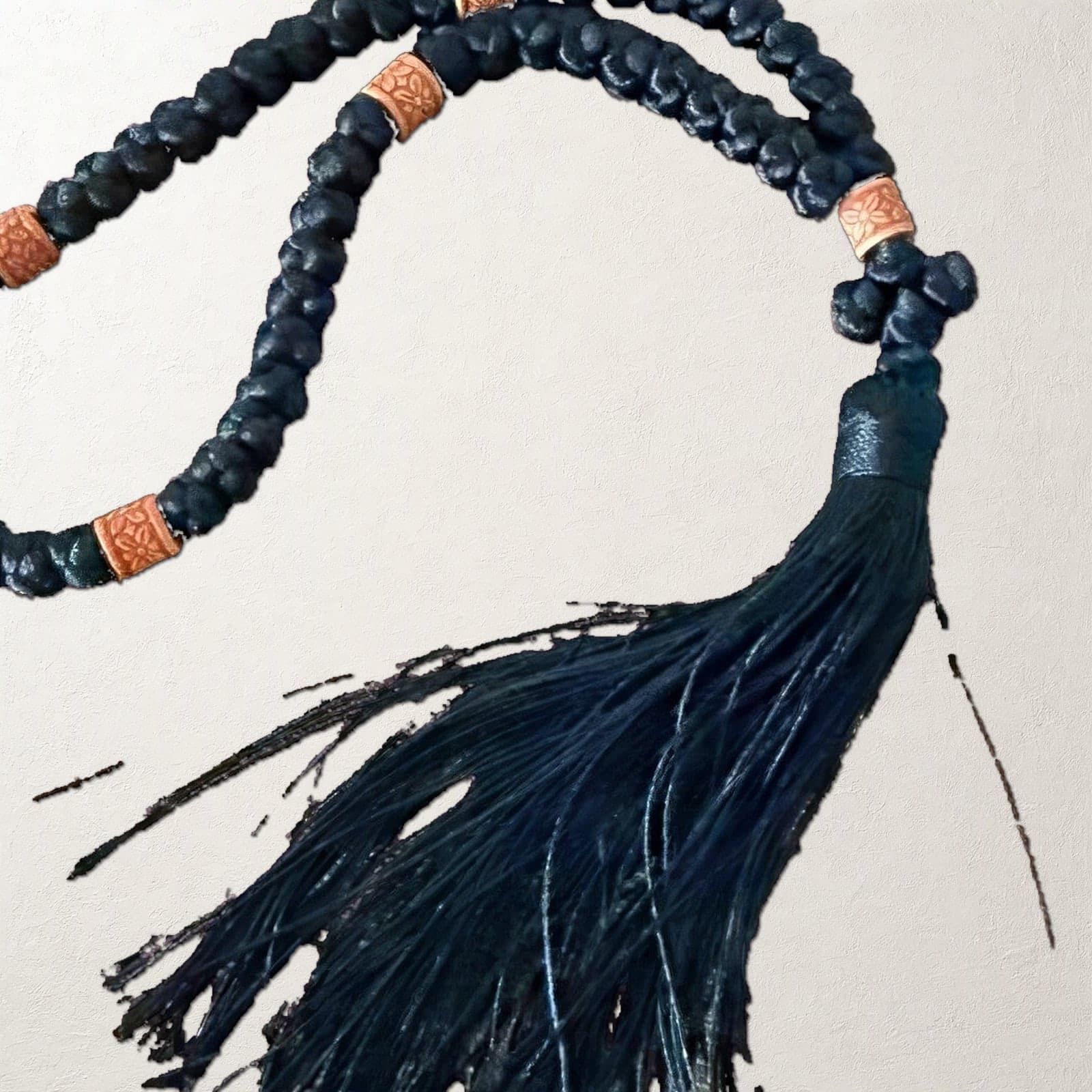 Close-up of the Orthodox Chotki Komboskini - Black Color - Wool Prayer Rope 50 Knots: the wool knots, wooden beads and tassel.