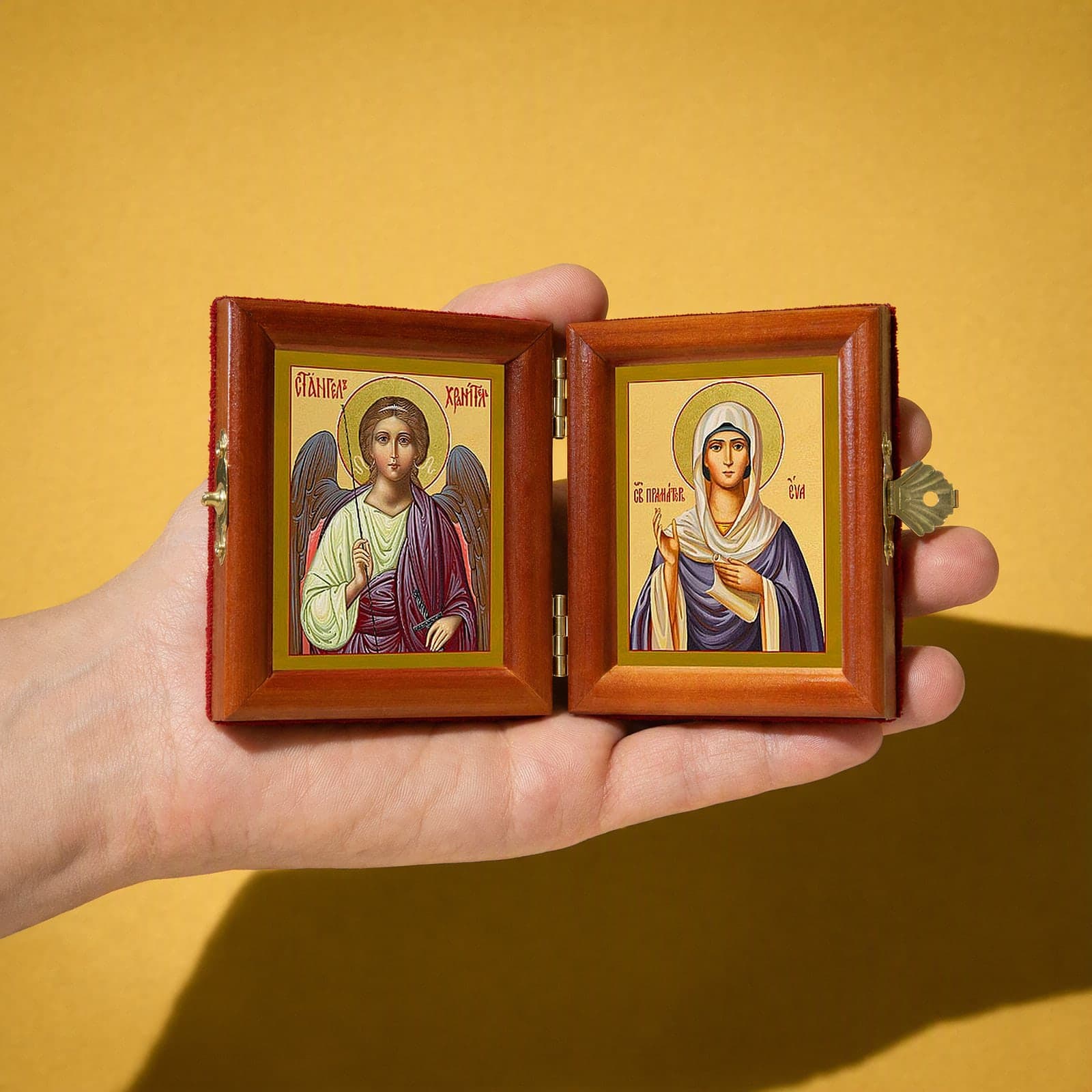 Holy Foremother Eve & Guardian Angel name diptych held open in one hand to show its size: 16.5 cm wide open, about two palm widths.